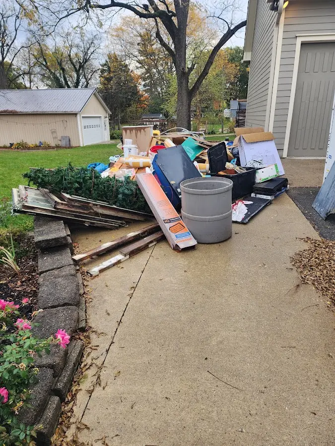 Dumpster being loaded with debris for Estate Cleanout Dumpster Rental in Surfside